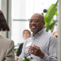 Edward Garner chatting with and smiling at colleague